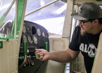 Student working on airplane electronics.