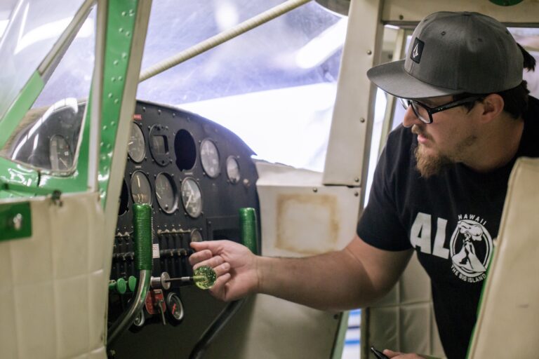 Student working on airplane electronics.